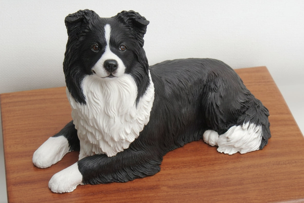Black and white dog figurine on a wooden surface