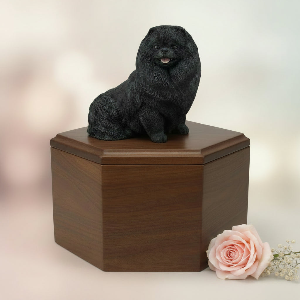 Wooden urn with a black pomeranian dog figurine on top against a white background